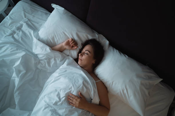 istock Cute girl sleeping in big bed, top view 1182652182