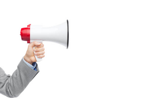 istock businessman in suit speaking to megaphone 1182653696