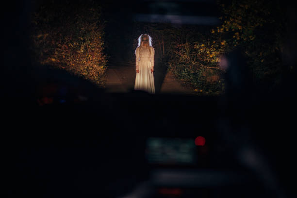 Witch standing in front of a car