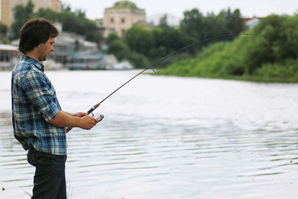 istock A man with a beard is fishing in the river 1182655366