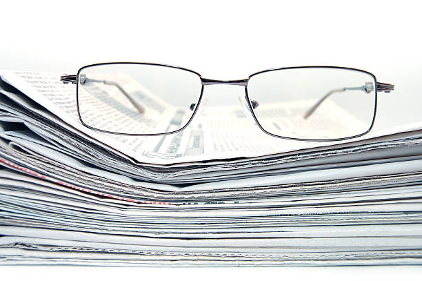 istock Pile of newspaper with eyeglasses 118265549