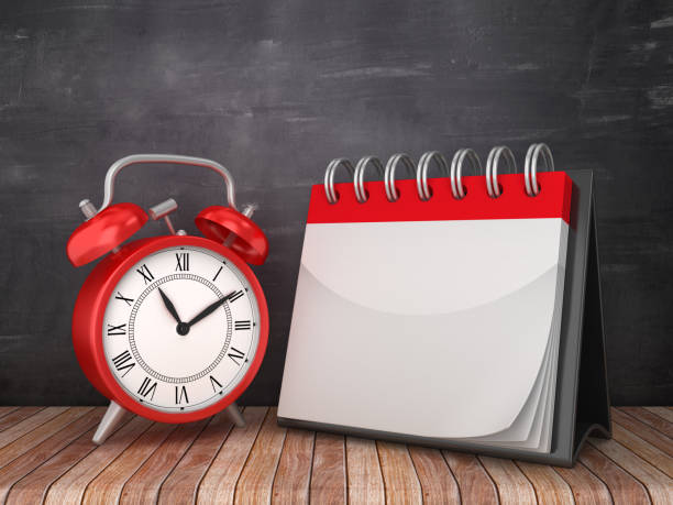 istock BLANK Calendar with Alarm Clock on Chalkboard Background - 3D Rendering 1182655503