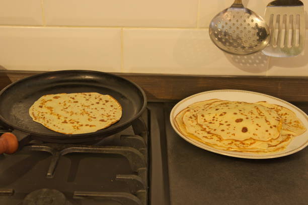 istock Pancakes on a plate. Pancake is cooked in a pan. 1182658993