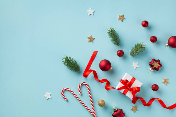 istock Flat lay composition made from gift box and holiday decorations on blue background top view. Christmas greeting card. 1182659102