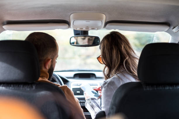 istock Couple in car looking global positioning system 1182659528