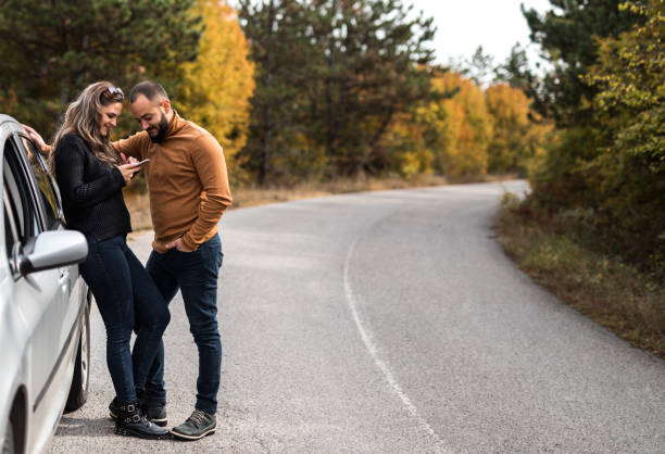 istock Couple on the road take a break from ride 1182660200