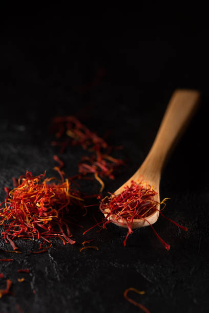 istock Saffron spices heap and in wooden spoon 1182661881