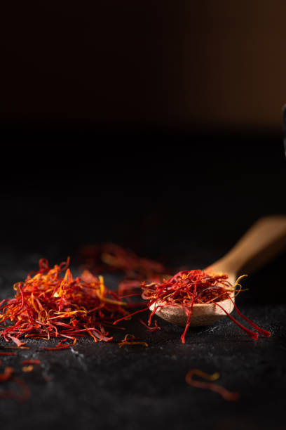istock Saffron spices heap and wooden spoon 1182661937