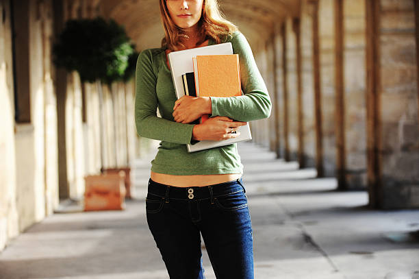 istock Female University Student with Books and Laptop Computer on Campus 118266204