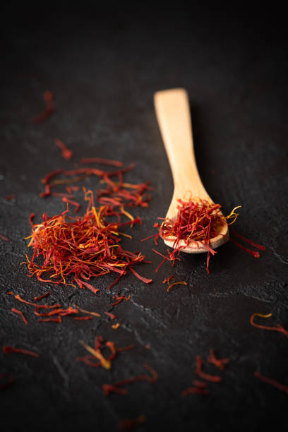 istock Saffron spices threads in wooden spoon 1182662256