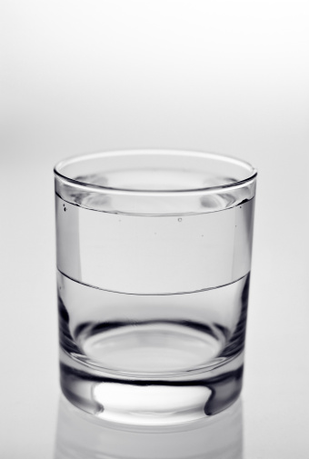 Half full glass, filled on top, empty at the bottom. Toned B&W. AdobeRGB