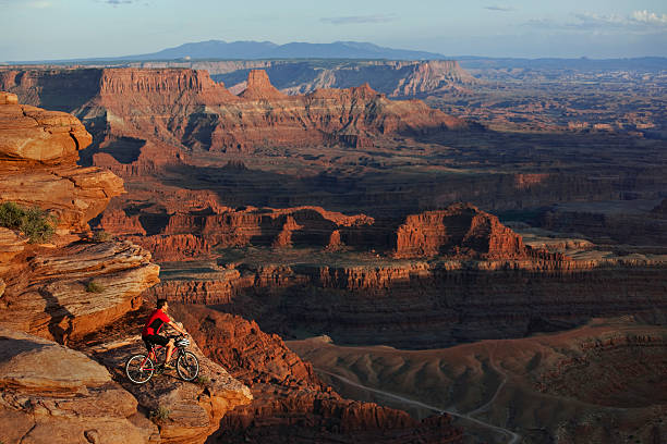 istock Mountain Biker Stopped on Rocky Ledge to Look At View 118266457