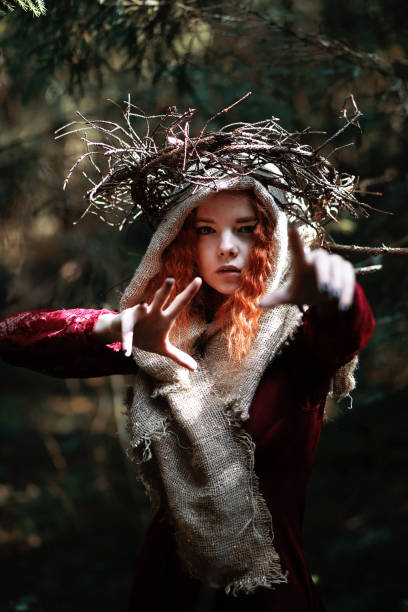 istock The red-haired witch holds a ritual with a crystal ball 1182667718