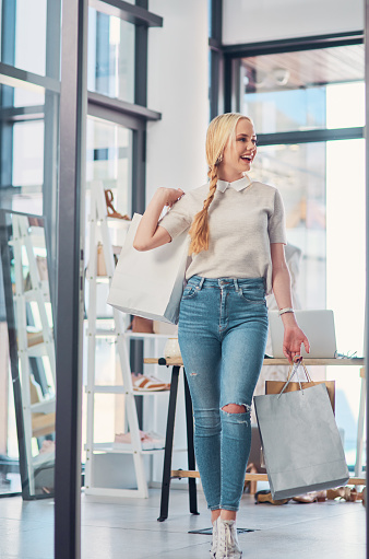 Shot of an attractive young woman carrying shopping bags