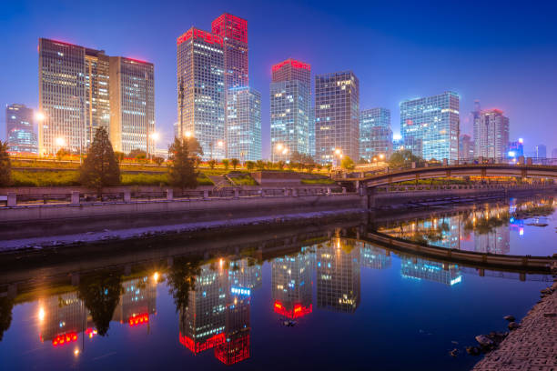 Beijing, China CBD city skyline and canal at night.