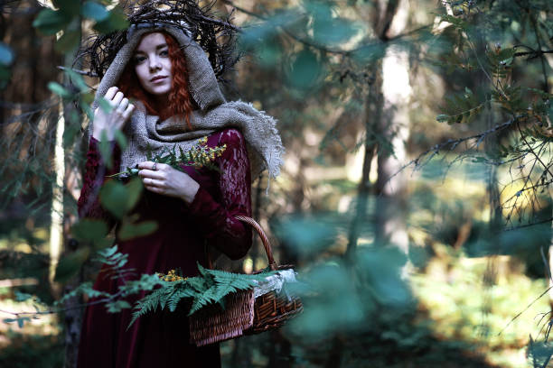 istock The red-haired witch holds a ritual with a crystal ball 1182670596