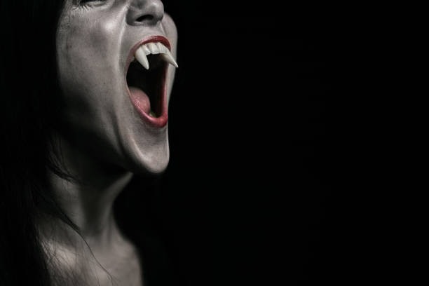 istock Halloween Vampire Beautiful Woman over black 1182672064