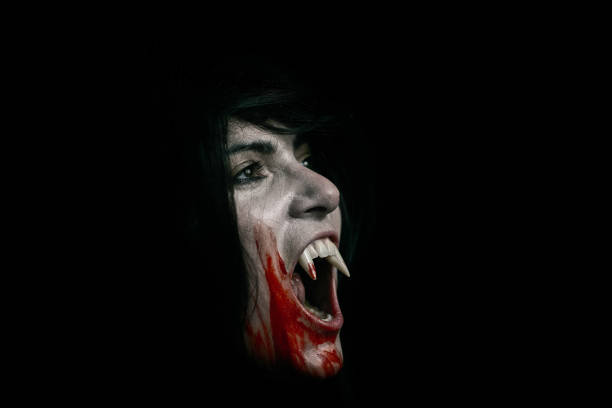 istock Halloween Vampire Beautiful Woman over black 1182672193
