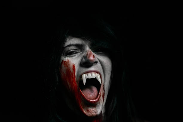istock Halloween Vampire Beautiful Woman over black 1182672415