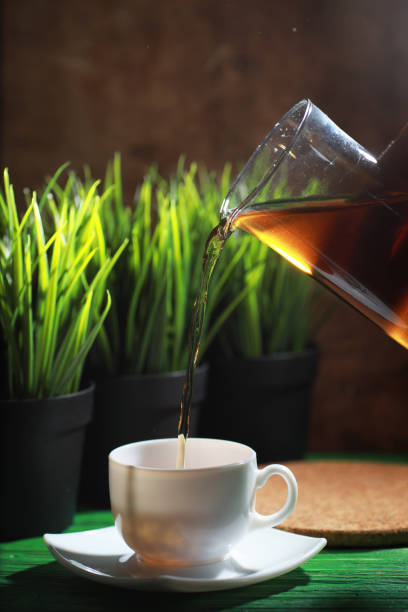 istock Brewing tea on a wooden table 1182673073