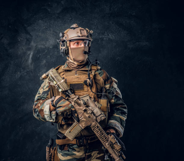 istock Elite unit, special forces soldier in camouflage uniform posing with assault rifle. 1182673335
