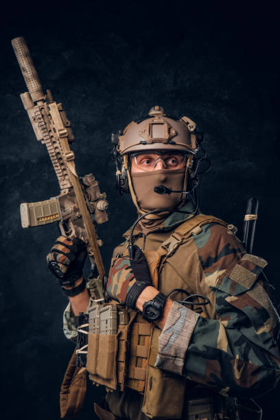 istock Elite unit, special forces soldier in camouflage uniform posing with assault rifle. 1182673357