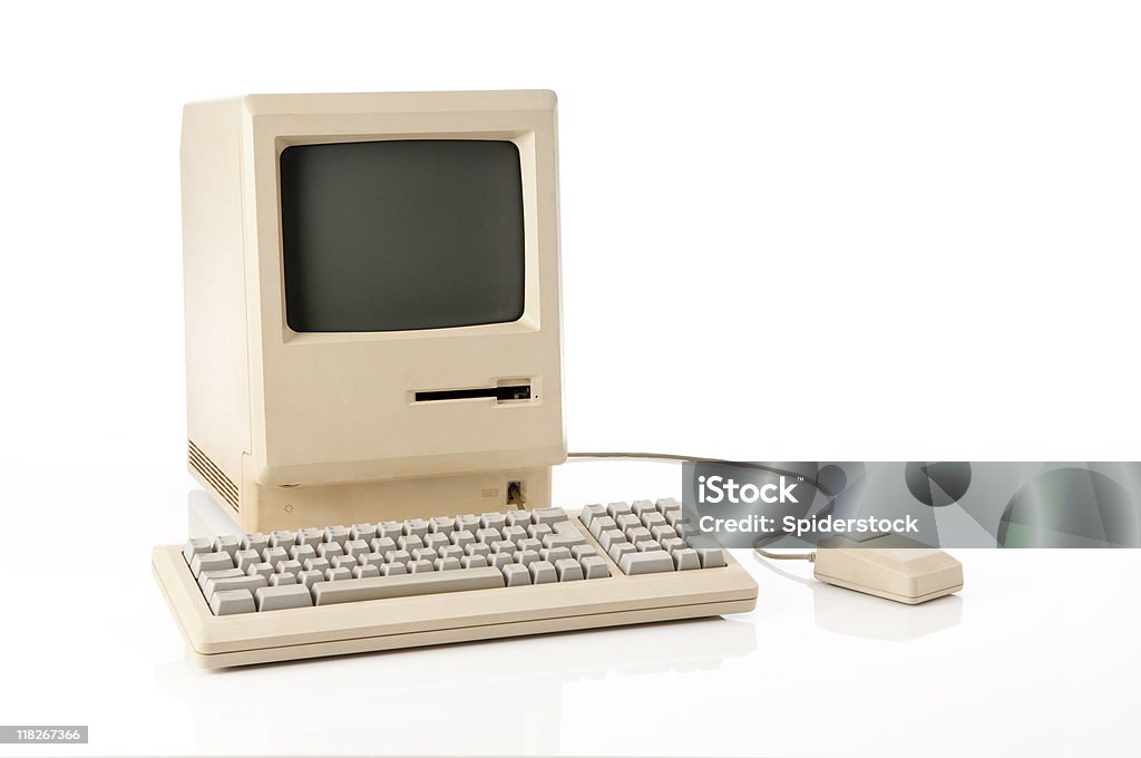 Old Apple Macintosh Classic Computer Old retro classic computer, keyboard and mouse. The image has a clipping path on both screen and main computer. Computer Stock Photo