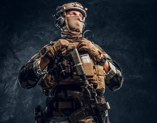 istock Elite unit, special forces soldier in camouflage uniform posing with assault rifle. 1182674480