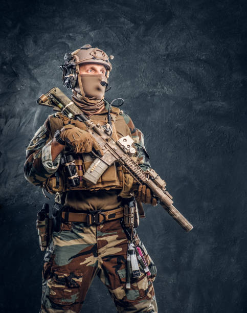 istock Elite unit, special forces soldier in camouflage uniform posing with assault rifle. 1182674686