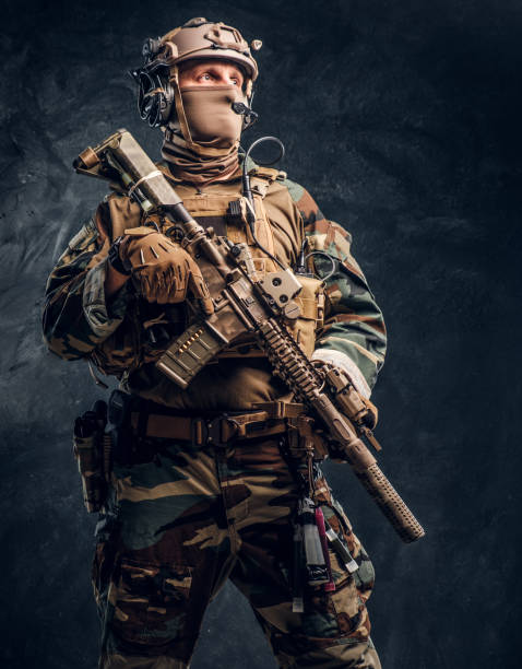 istock Elite unit, special forces soldier in camouflage uniform posing with assault rifle. 1182675454
