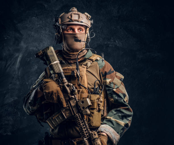 istock Elite unit, special forces soldier in camouflage uniform posing with assault rifle. 1182675787