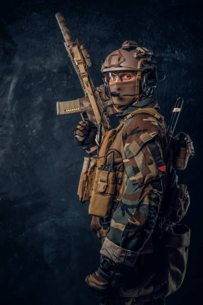 istock Elite unit, special forces soldier in camouflage uniform posing with assault rifle. 1182676037