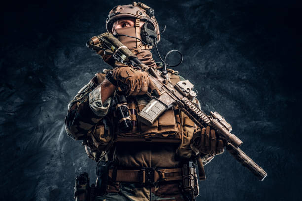 istock Elite unit, special forces soldier in camouflage uniform posing with assault rifle. 1182676161