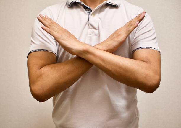 man made X sign shape mean to say no man in white T-shirt made X sign shape mean to say no body language crossed arms stock pictures, royalty-free photos & images