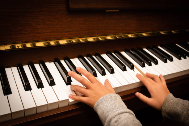 istock Child's hand playing the piano 1182679635