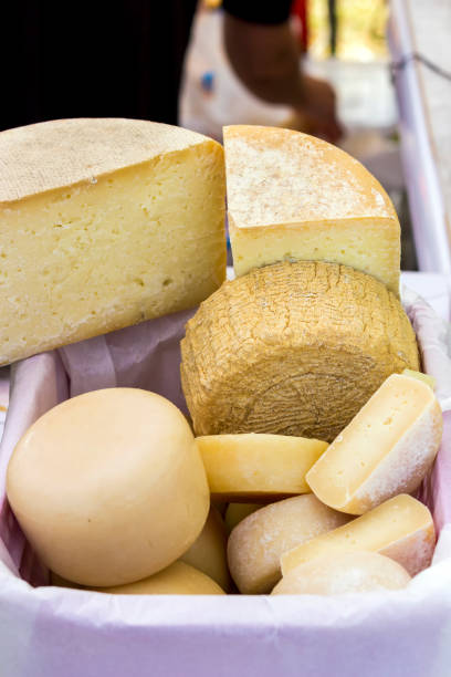 istock hard cheeses sliced on a wooden board on a dark rustic background 1182679656