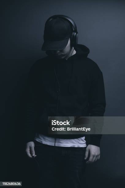 Young Cool Rapper With Black Hoodie And Cap Looking Down And Listening  Music Stock Photo - Download Image Now - iStock
