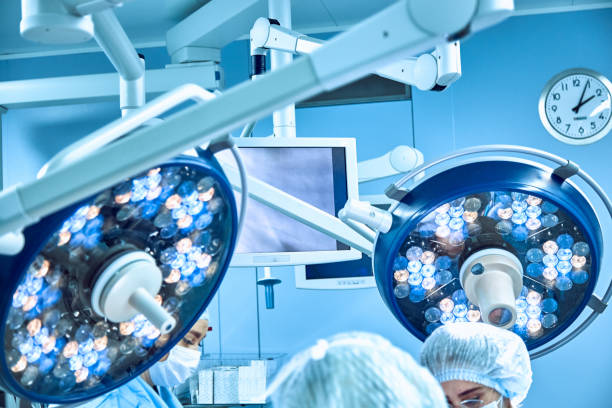 istock Two surgical lamps in operation room take with art lighting and blue filter 1182681496