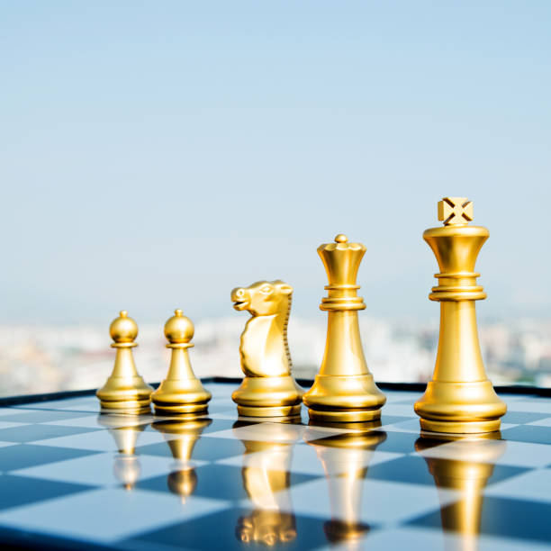 istock Golden chess pieces on the board 1182682745