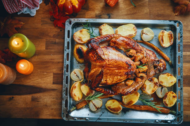 istock Preparing Stuffed Turkey for Holidays in Domestic Kitchen 1182683198
