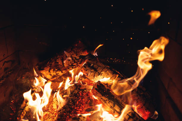 istock burning fire logs with sparks in the fireplace 1182683263