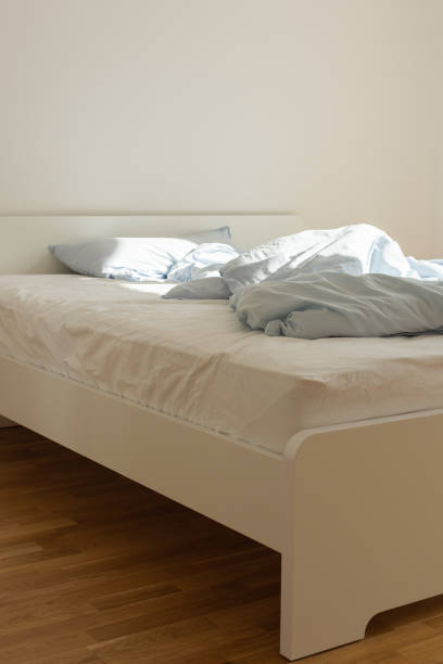 istock Bed after sleeping in the morning in the sun 1182683278