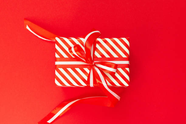 istock Background with red and white striped gift box 1182683301