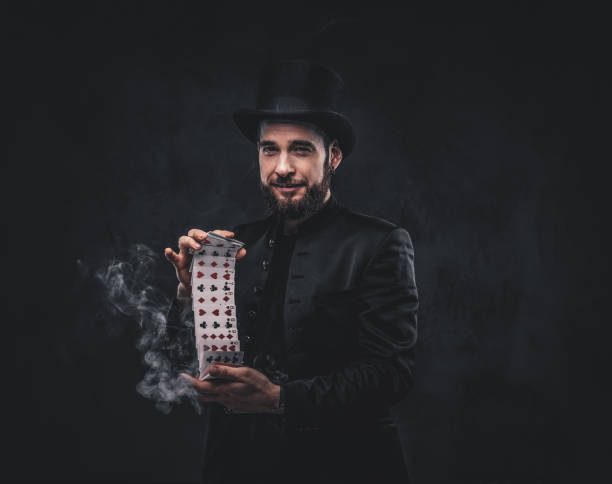 istock Magician showing trick with playing cards. 1182683350