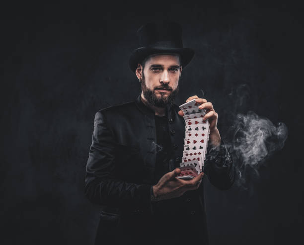istock Magician showing trick with playing cards. 1182683404