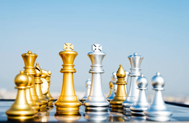 istock Golden and silver chess pieces on the board 1182683480