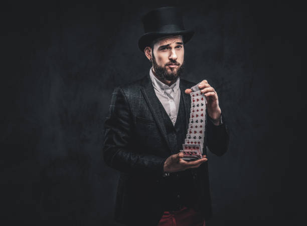 istock Magician showing trick with playing cards. 1182683988