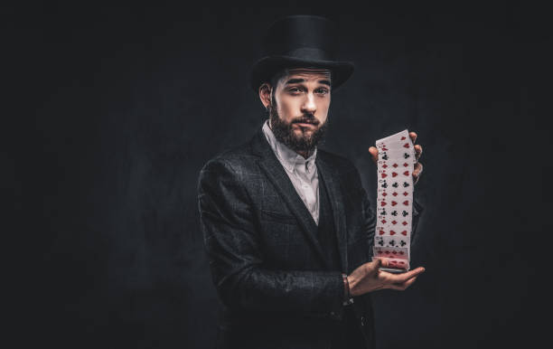 istock Magician showing trick with playing cards. 1182684012