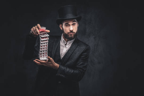 istock Magician showing trick with playing cards. 1182684120