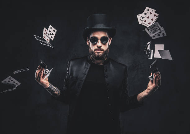 istock Magician showing trick with playing cards. 1182684147